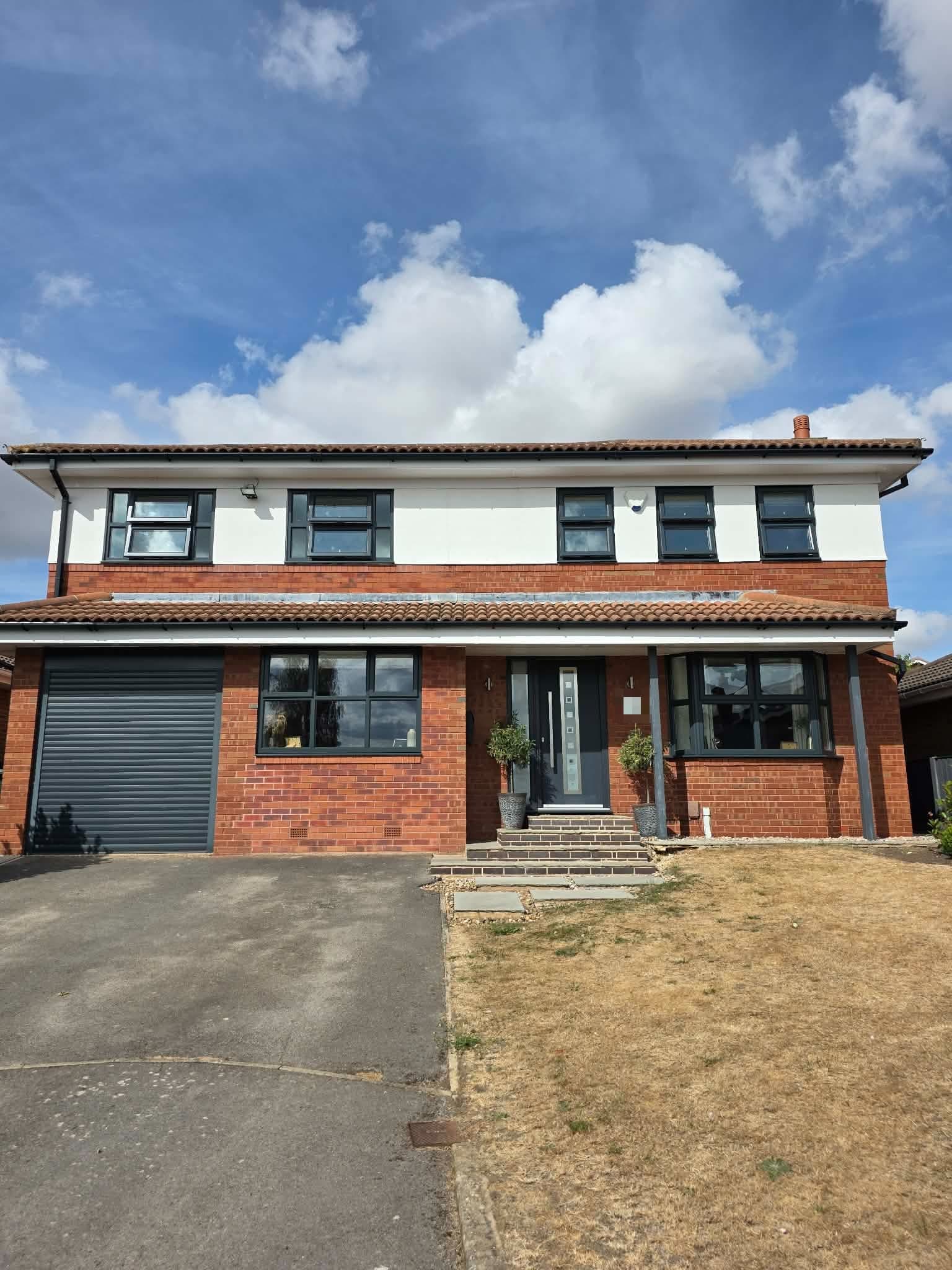 The same house after its uPVC windows were resprayed anthracite grey