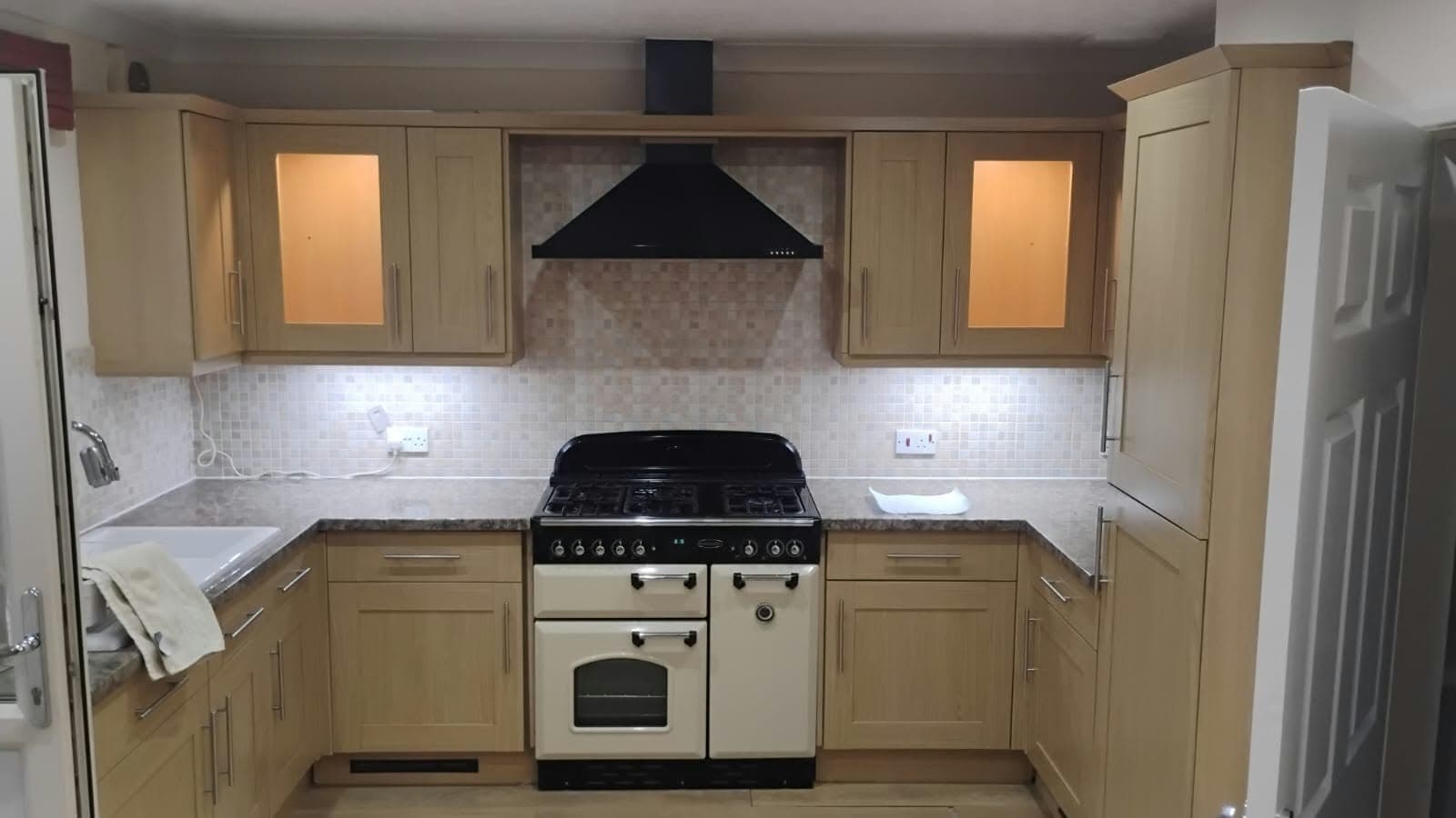 Oak shaker-style kitchen with a cream range cooker, before respraying